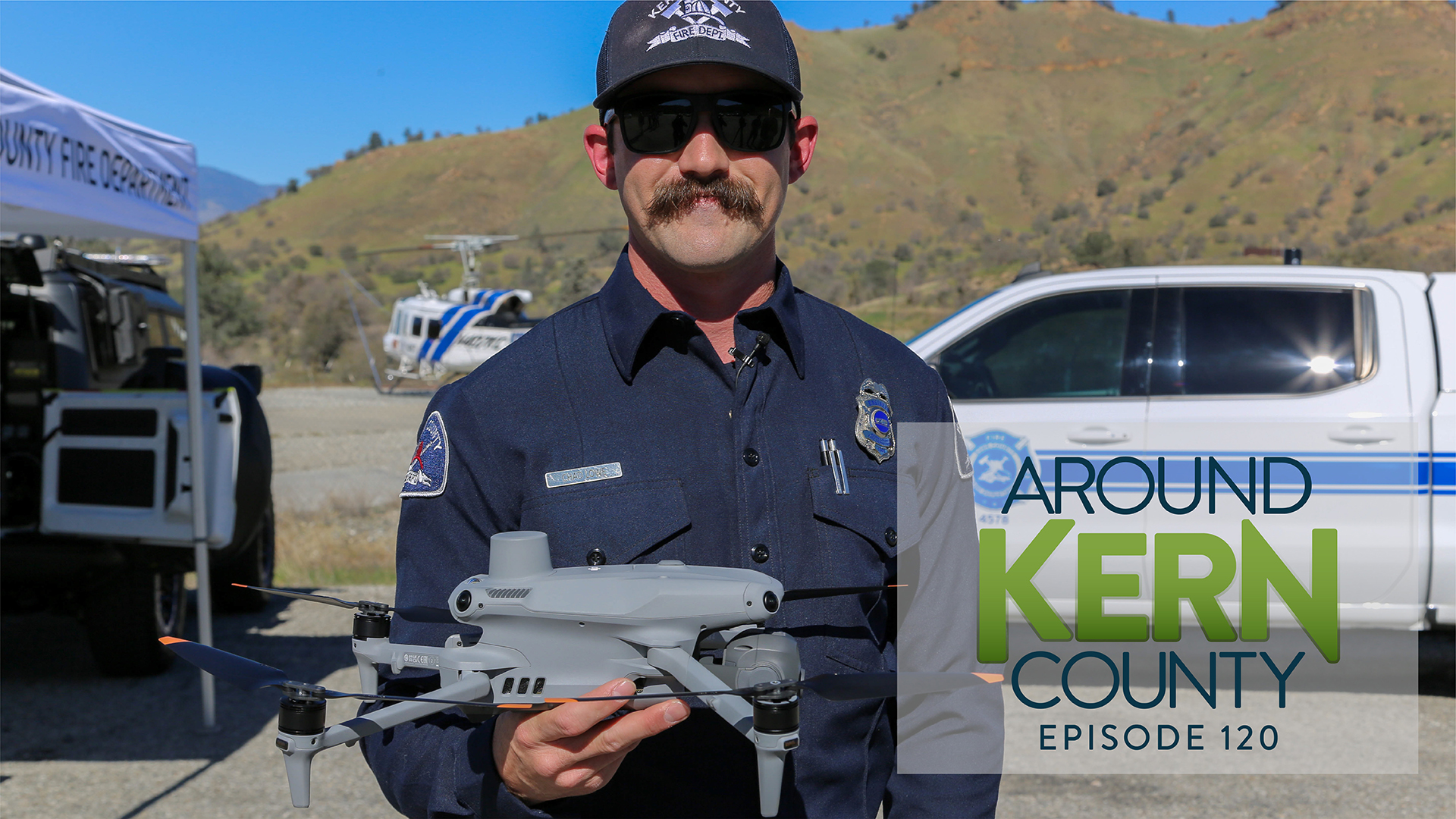 Kern County Firefighter holding a drone to demonstrate its newly added technology