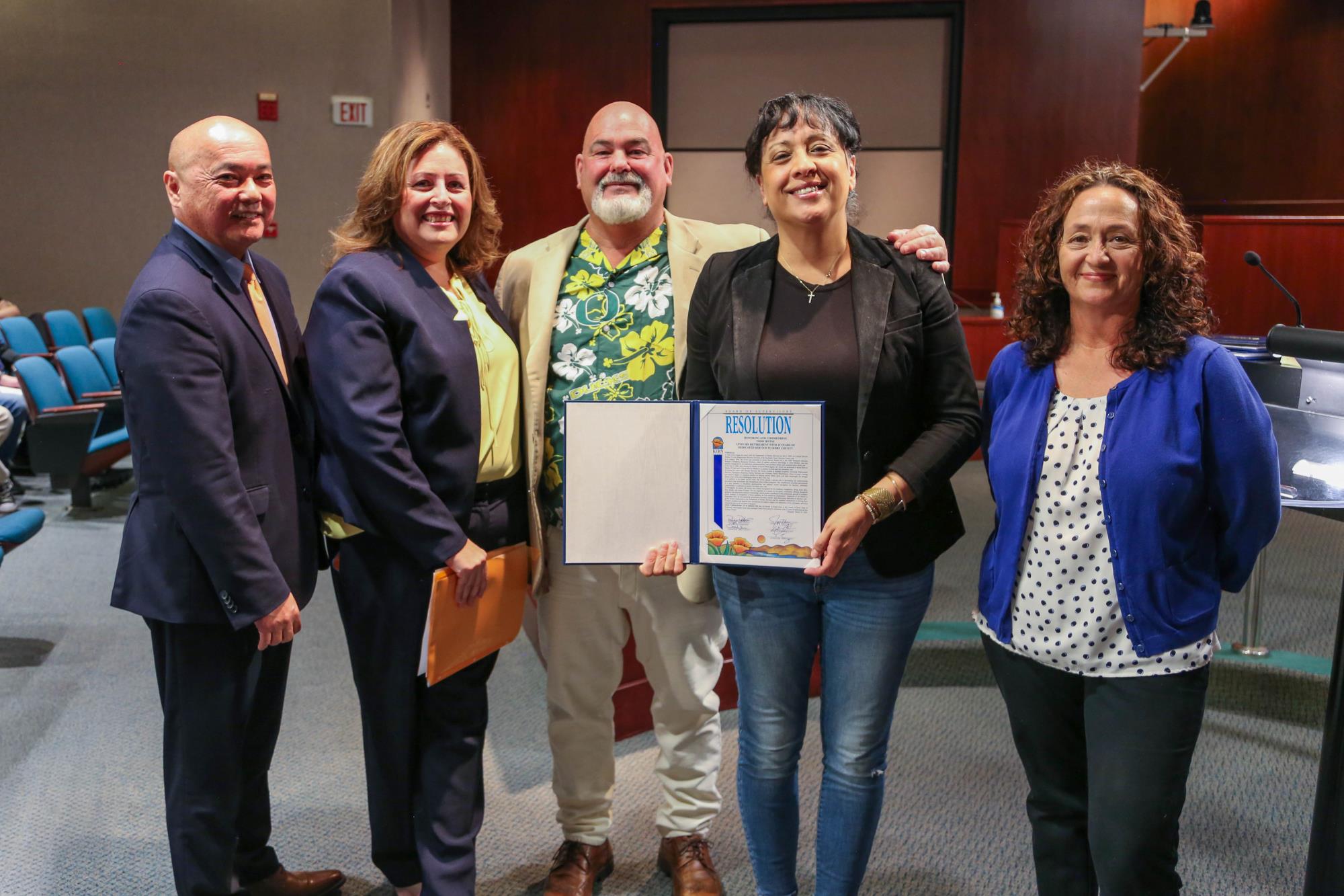 Supervisor Leticia Perez presenting a retirement resolution to Todd Irvine for 31 years of dedicated service