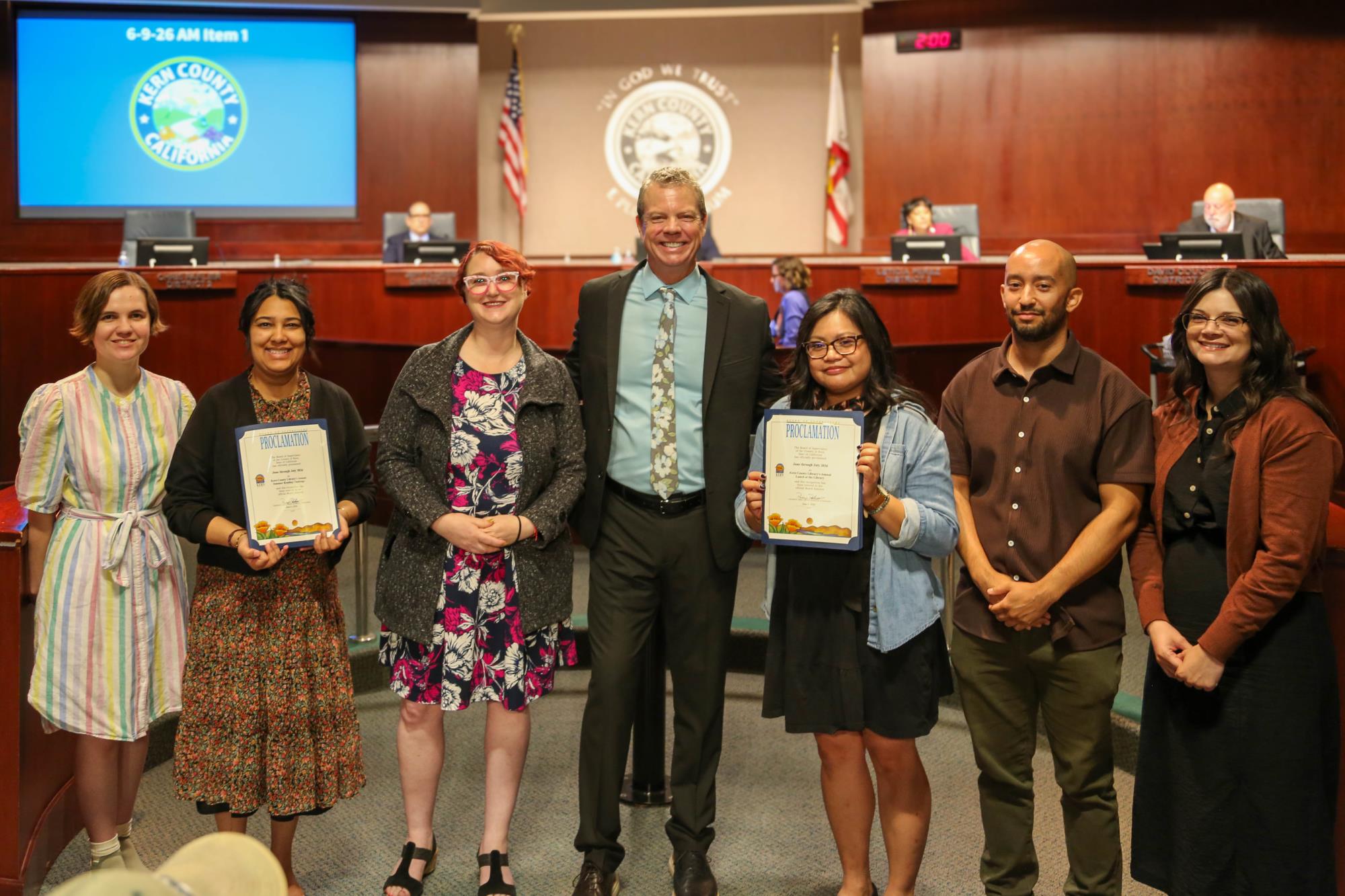 Board proclamation for the Library Reading Challenge. Photo with library staff and Supervisor Chris Parlier
